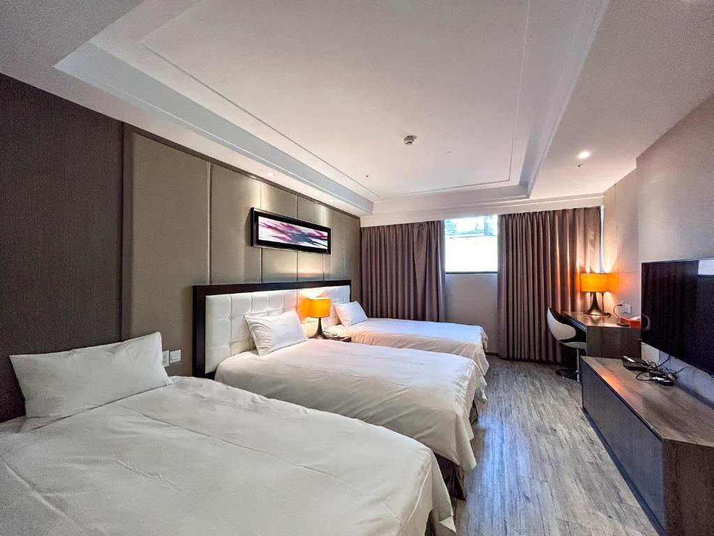 Postel nebo postele na pokoji v ubytování Royal Fine Hotel