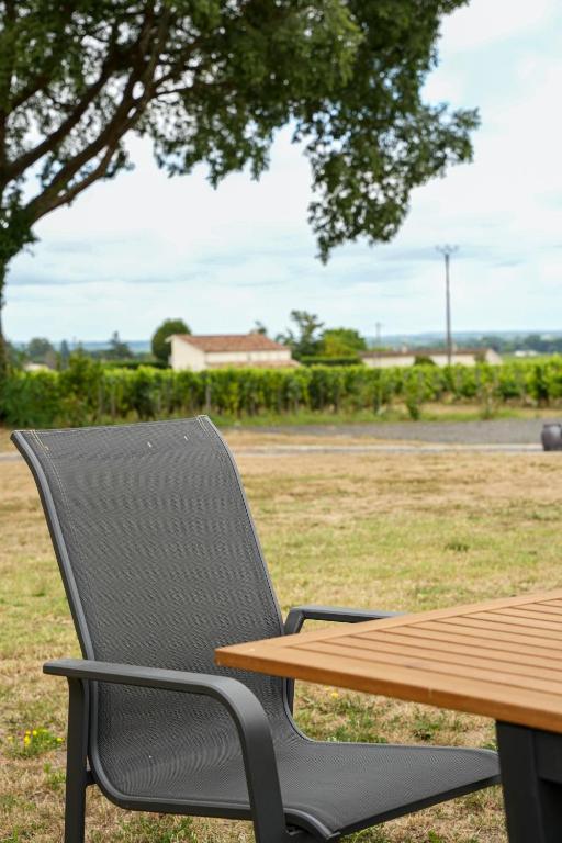 a chair sitting next to a picnic table at Château Vieux Clos Saint Émilion in Saint-Émilion