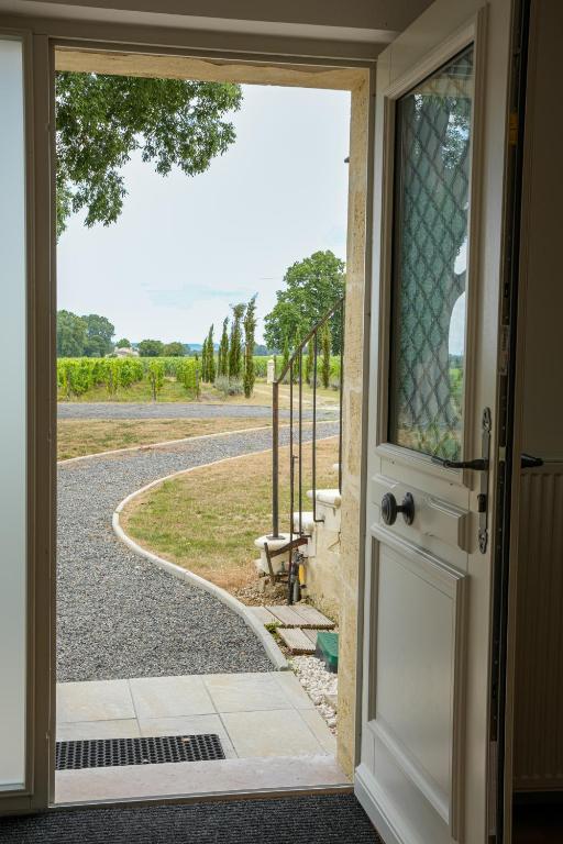 an open door with a view of a road at Château Vieux Clos Saint Émilion in Saint-Émilion