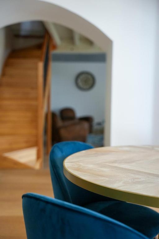 a wooden table and blue chairs in a room at Château Vieux Clos Saint Émilion in Saint-Émilion