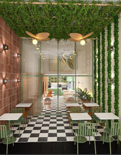 a restaurant with tables and chairs on a checkered floor at Lord Morgan & Exclusive Design Residence Nişantaşı in Istanbul