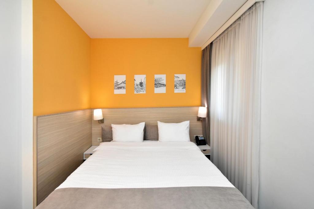 Postel nebo postele na pokoji v ubytování In City Hotel