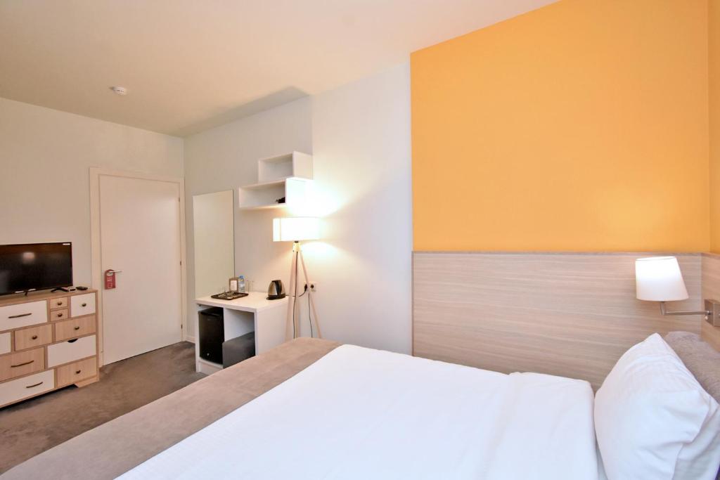 Postel nebo postele na pokoji v ubytování In City Hotel