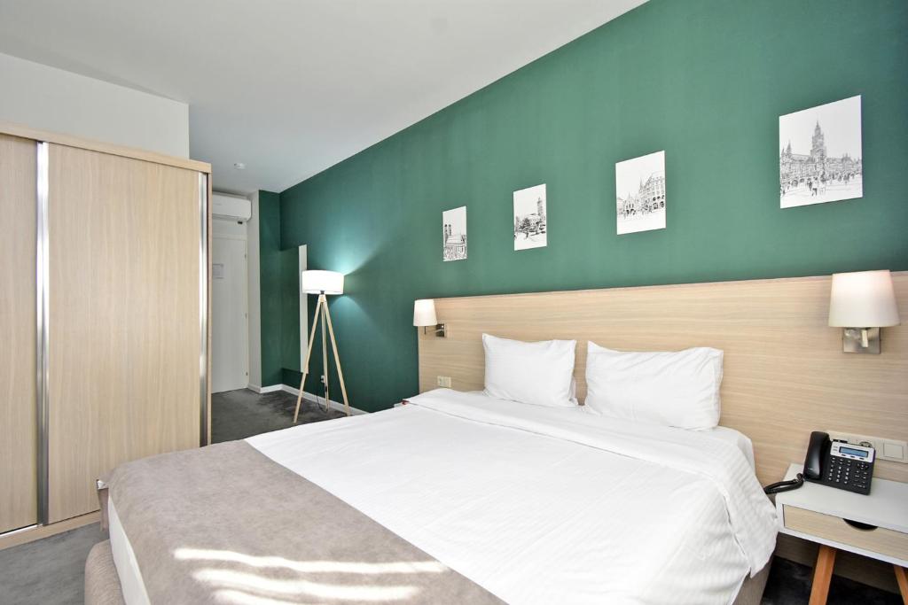 Postel nebo postele na pokoji v ubytování In City Hotel