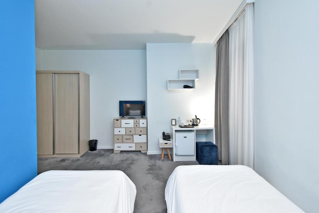 Postel nebo postele na pokoji v ubytování In City Hotel
