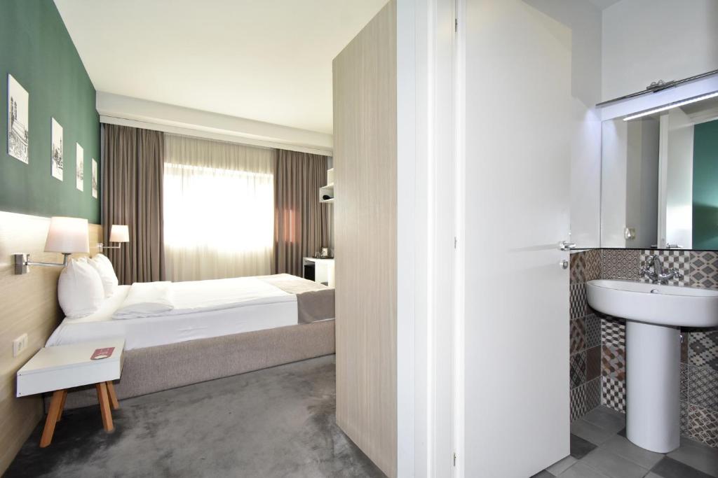 Postel nebo postele na pokoji v ubytování In City Hotel