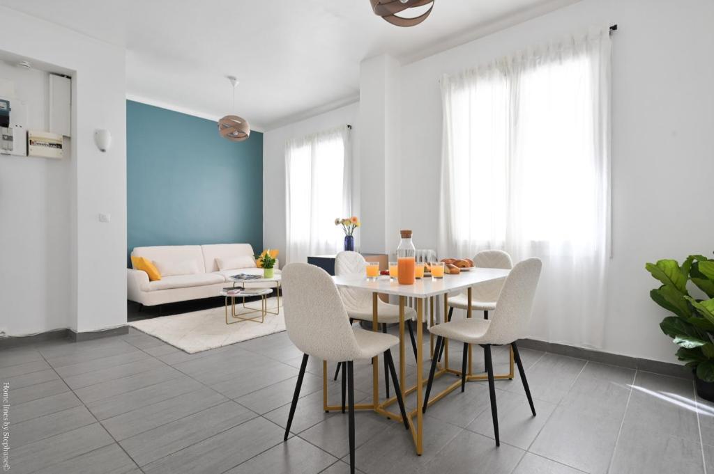 un salon avec une table et des chaises blanches dans l'établissement À 2 Pas de la plage des catalans, à Marseille