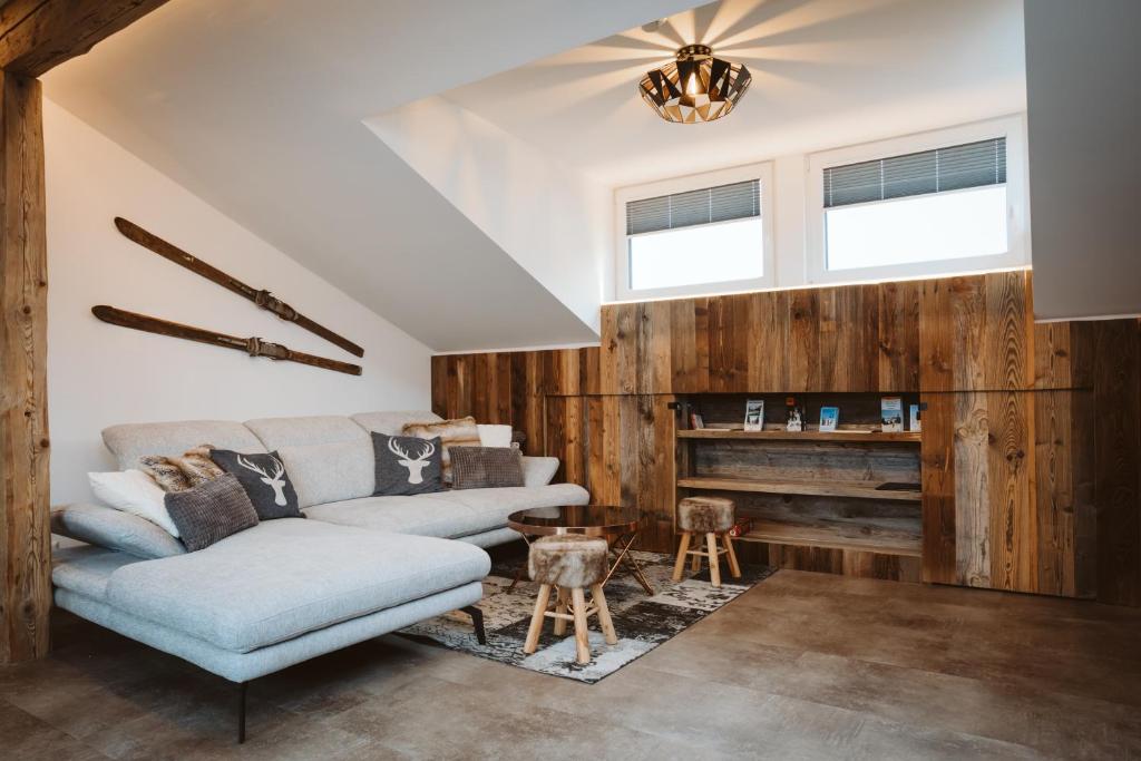 a living room with a couch and a table at Panorama Lodge Edelweiss in Gosau