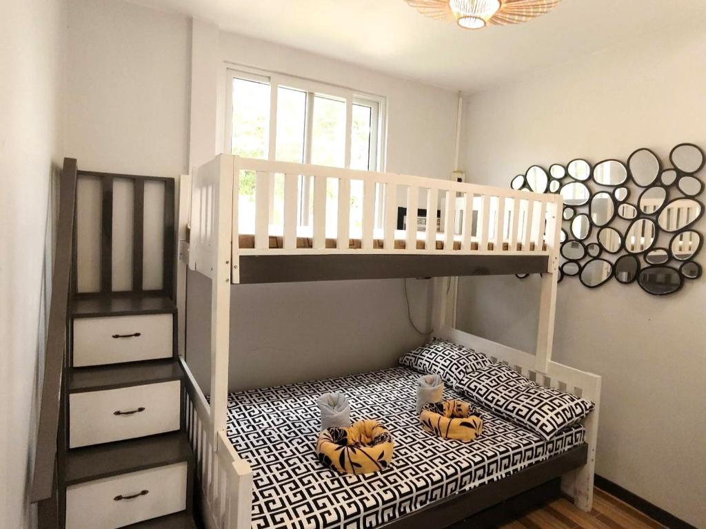 a bunk bed with two teddy bears sitting on the bottom bunk at Apong Martina's Guest House La Union in Lacong