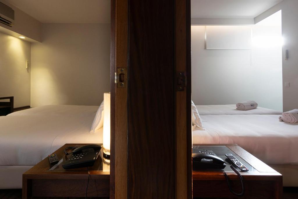 Een bed of bedden in een kamer bij Hotel Rali Viana