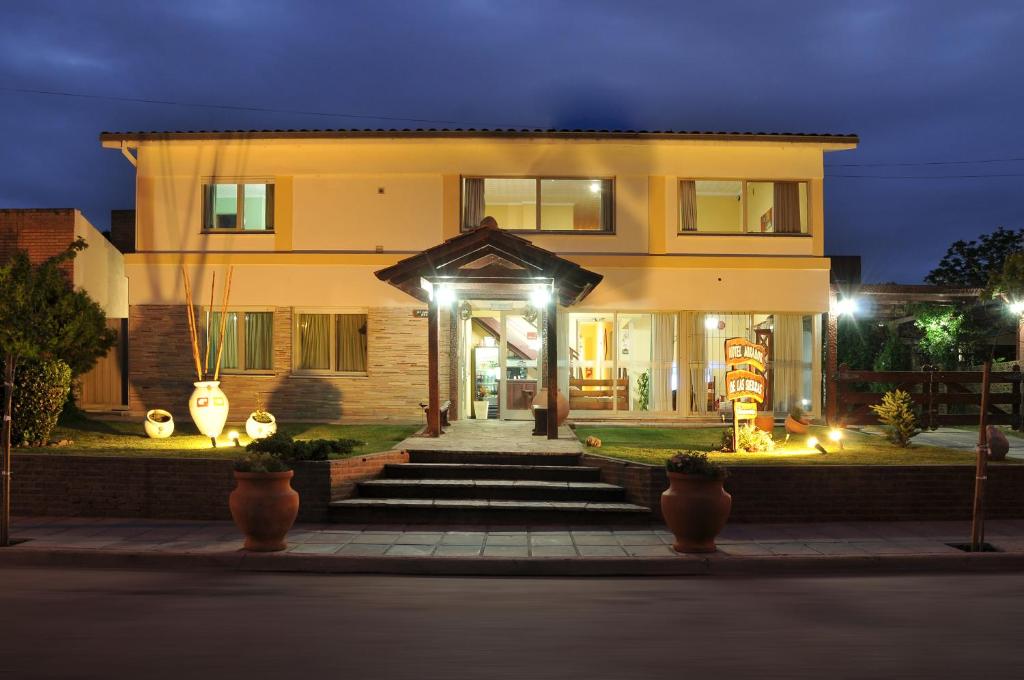a house with lights on the front of it at Hotel Mirador de las Sierras in Villa Carlos Paz