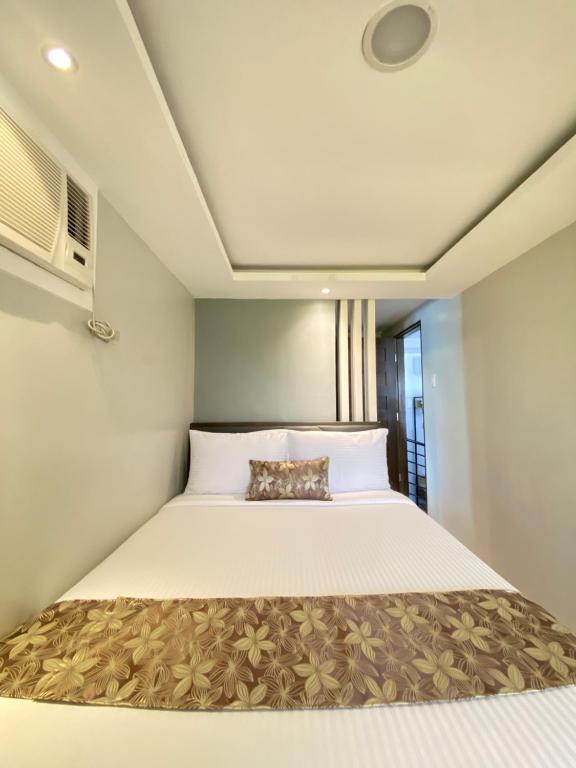 Postel nebo postele na pokoji v ubytování Buenaventura Suites