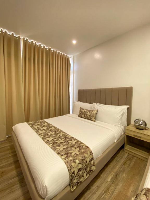 Postel nebo postele na pokoji v ubytování Buenaventura Suites