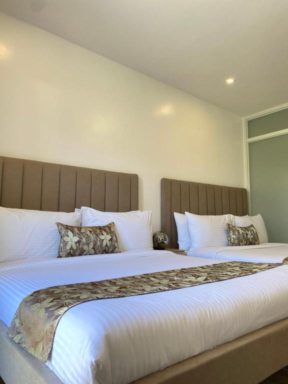 Postel nebo postele na pokoji v ubytování Buenaventura Suites