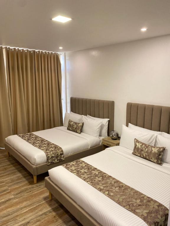 Postel nebo postele na pokoji v ubytování Buenaventura Suites