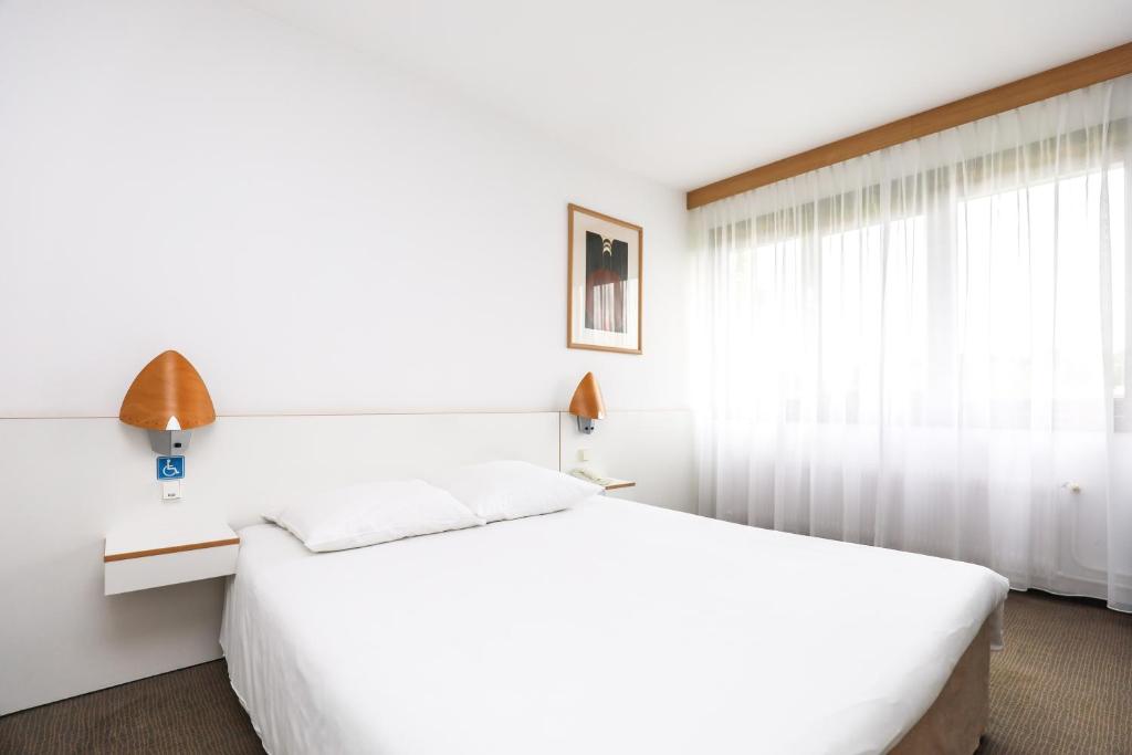 Posteľ alebo postele v izbe v ubytovaní Novotel Poznań Malta