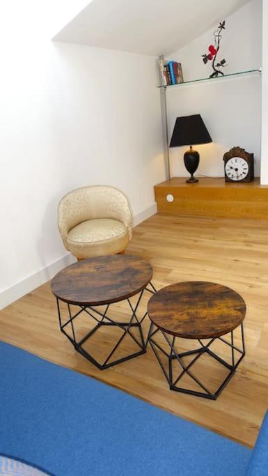 un salon avec une chaise et deux tables dans l'établissement Clim-Ascenseur T2 Capitole à 5' Gare à 7', à Toulouse