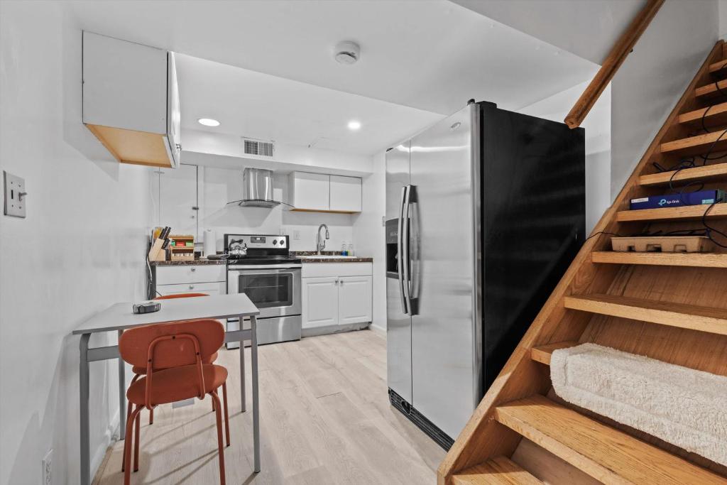 a kitchen with a black refrigerator and a table at Cozy 1-bedroom garden apartment in Silver Spring