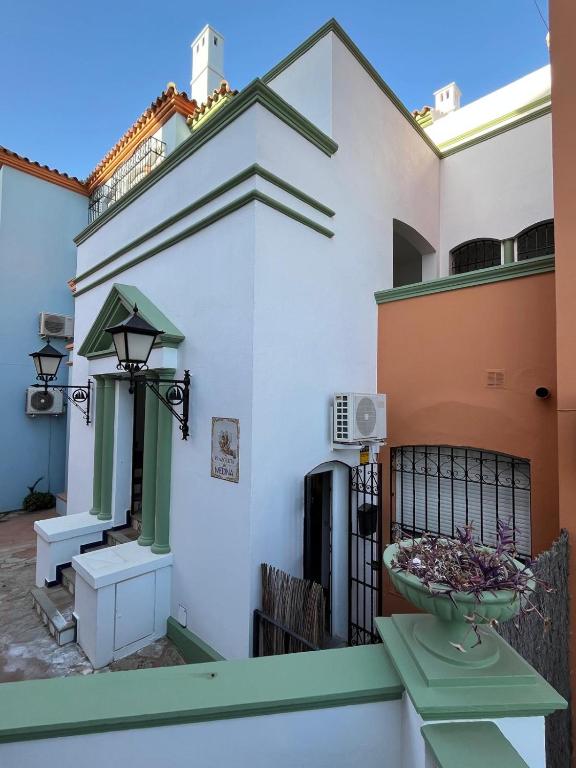 a balcony of a house with a bowl of flowers at Galatea Puerto Sherry Apartamento in El Puerto de Santa María