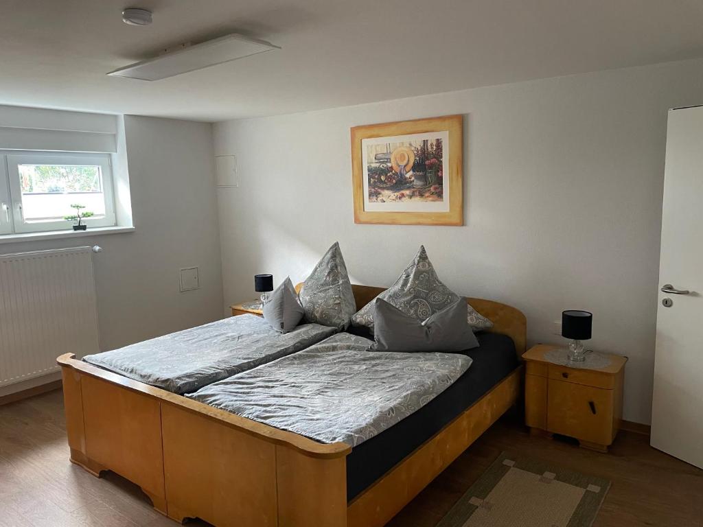 a bedroom with a wooden bed in a room at Ferienwohnung im Grünen in Lebach