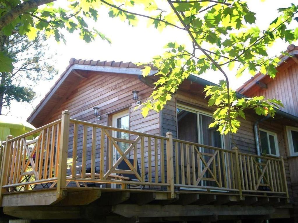 a log cabin with a large wooden deck at Chez fontaine in Lahonce