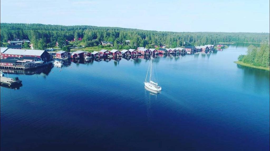 a sailboat is docked at a dock in the water at Hotell Mellanfjärden in Jättendal