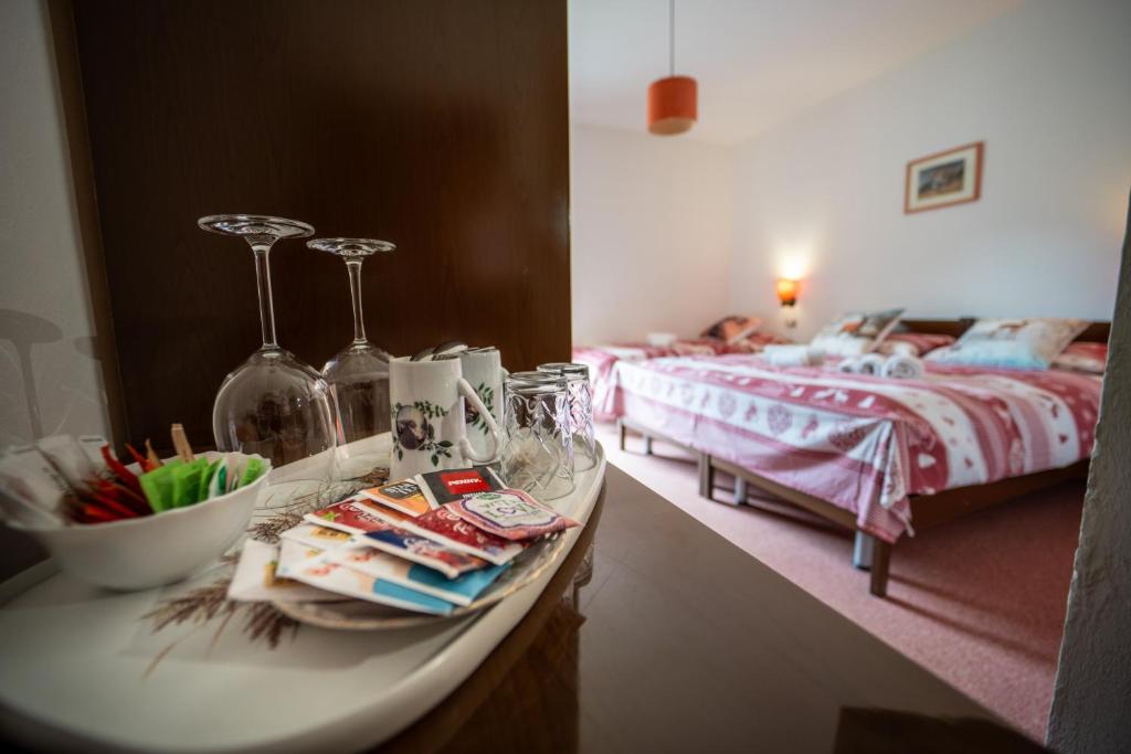 a room with two beds and a counter with a table with a bed at Cèsa Cherpei - Dog Friendly in Campitello di Fassa