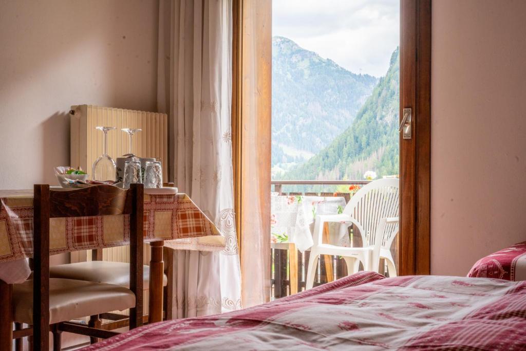 a room with a window with a view of a mountain at Cèsa Cherpei - Dog Friendly in Campitello di Fassa