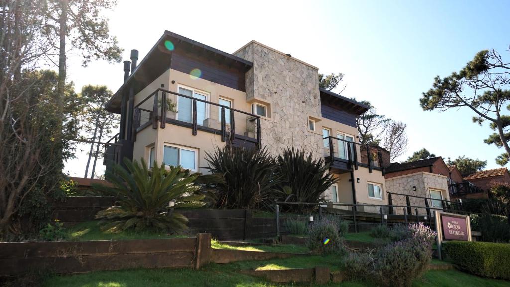 a large house with a lot of windows at Bosque de Ciruelos in Carilo