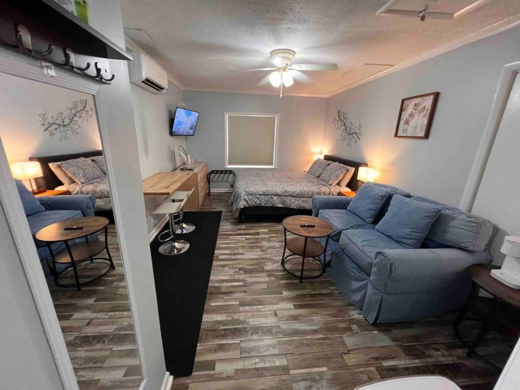a living room with a blue couch and a bed at Cozy Studio Retreat. Pet Yes in Beaufort