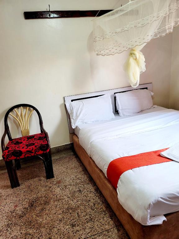 Postel nebo postele na pokoji v ubytování Nairobi City Space Hotel