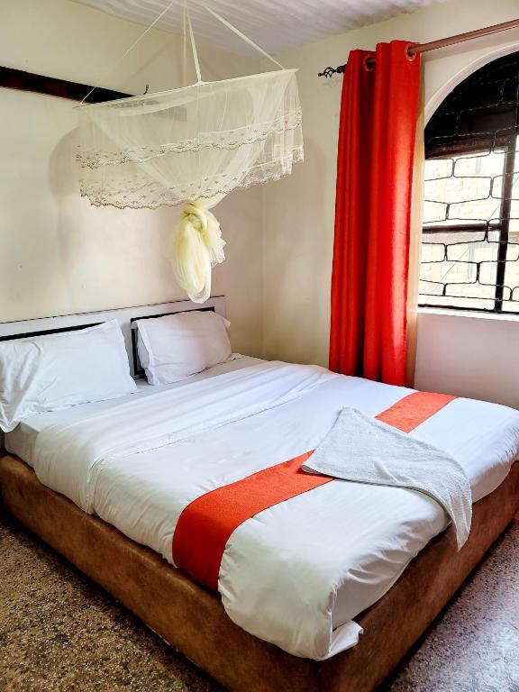 Postel nebo postele na pokoji v ubytování Nairobi City Space Hotel
