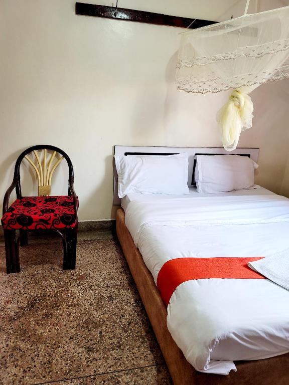Postel nebo postele na pokoji v ubytování Nairobi City Space Hotel