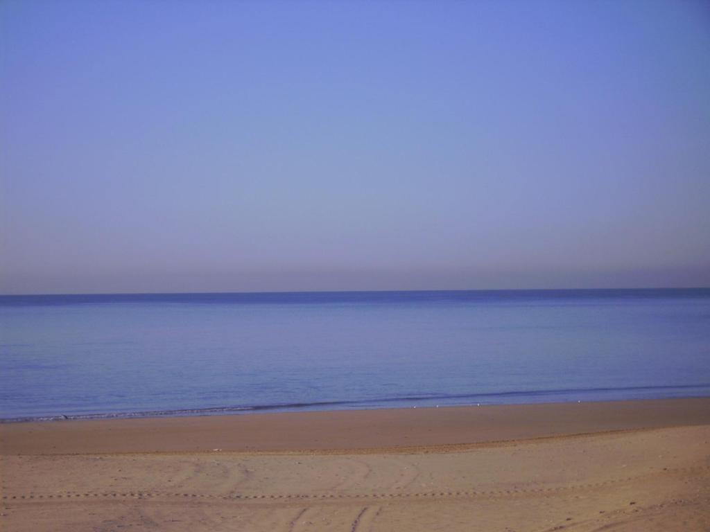 an empty beach with the ocean in the background at Macavi in Rota