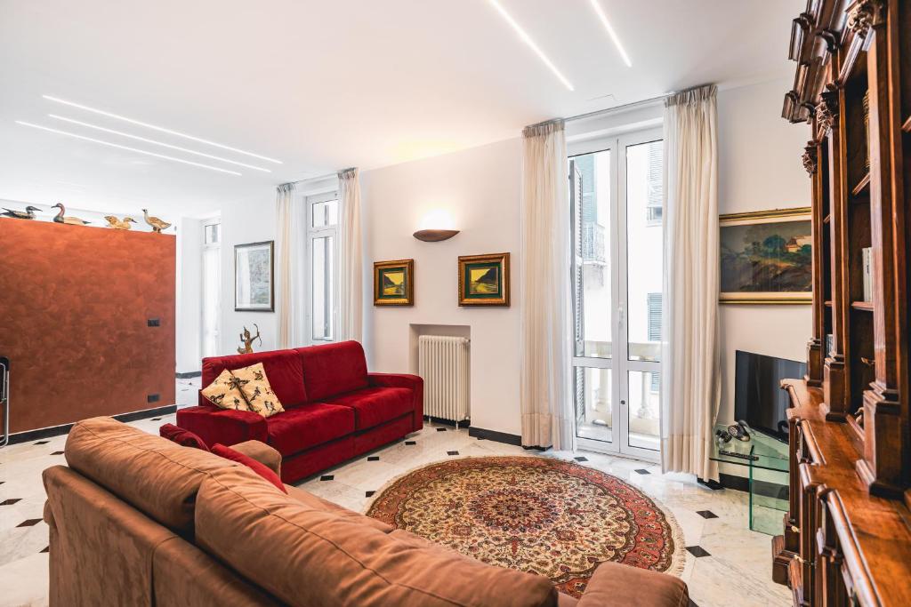 a living room with a red couch and a fireplace at palmaria suite -the duck nest in Genoa
