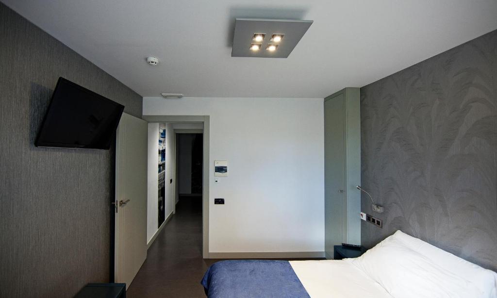 Posteľ alebo postele v izbe v ubytovaní Hostal Averroes