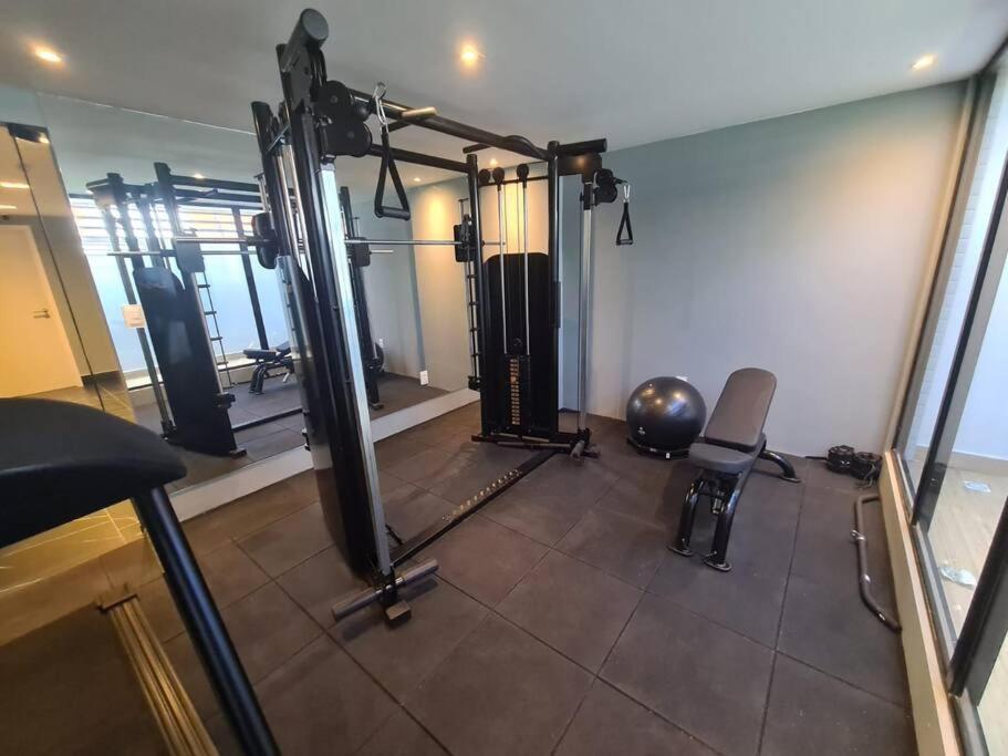 a room with a gym with several tread machines at Melhores Flats - Espaçoso, pertinho do mar in João Pessoa