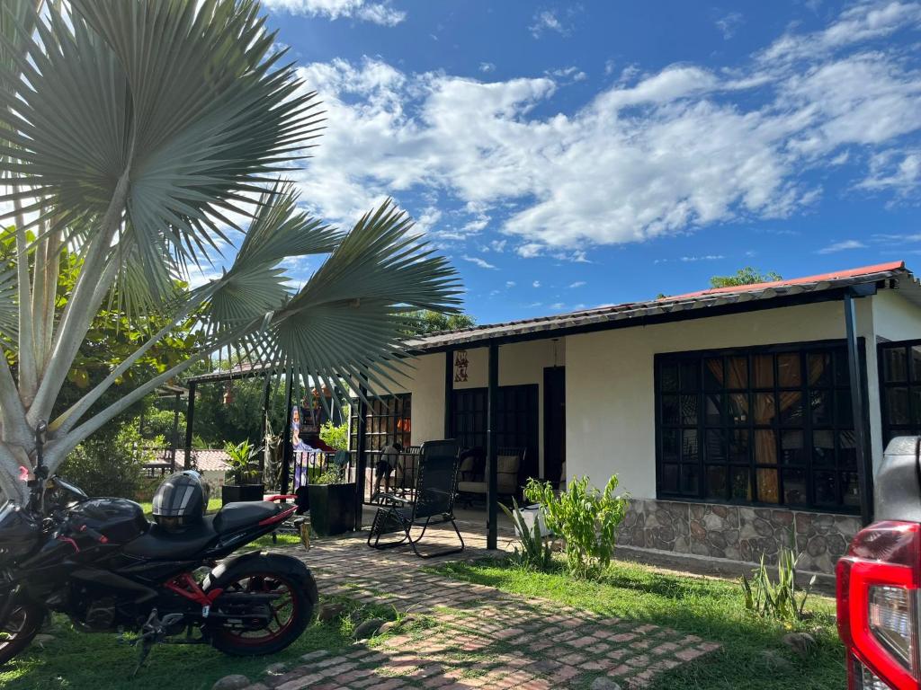 a motorcycle parked in front of a house at Villa Gloria - Carmen de Apicalá in San Antonio