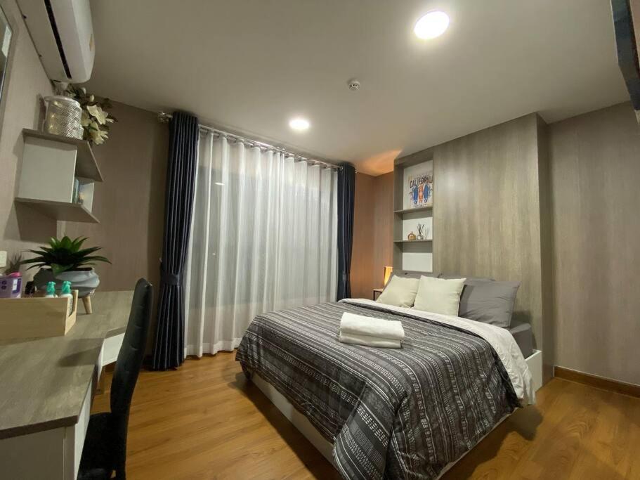 a bedroom with a bed and a desk in it at 501B #1km to central festival #5 km to lee garden in Ban Khlong Wa