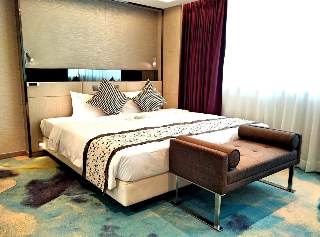 a bedroom with a large bed and a chair at Sohotel in Hong Kong