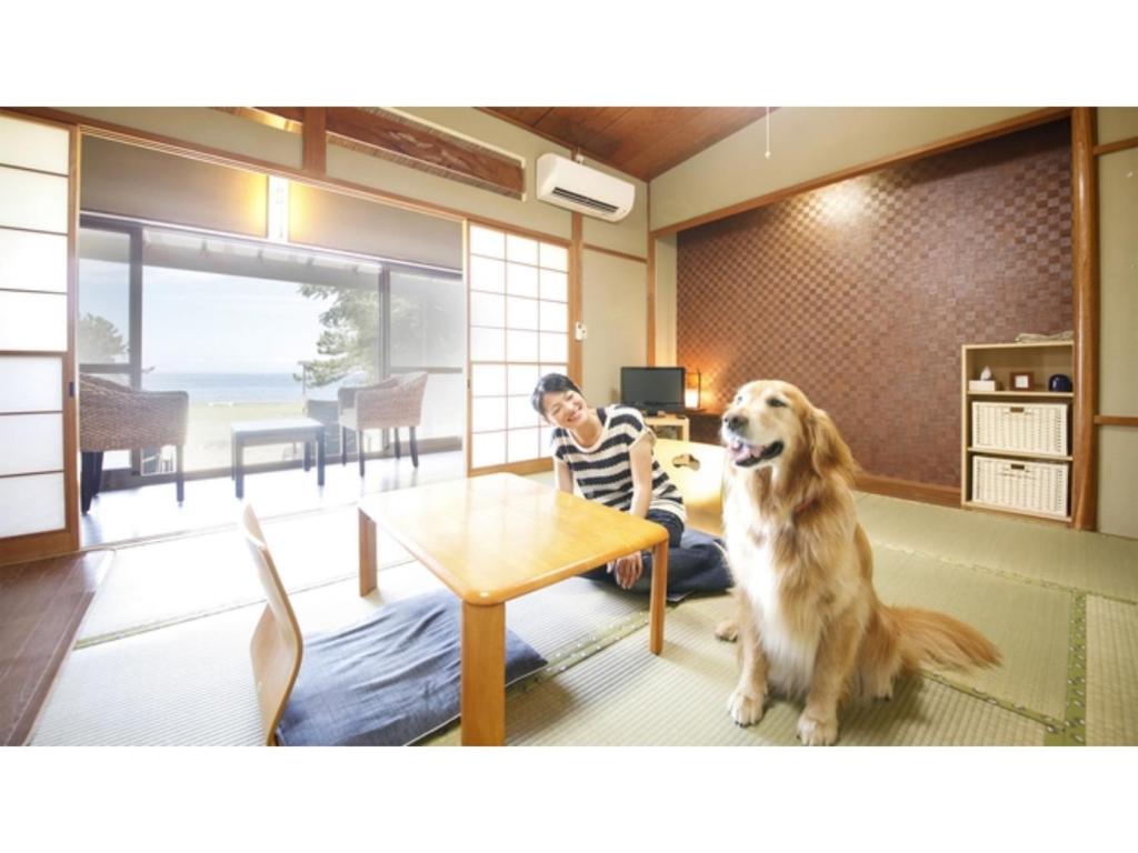 a woman and a dog sitting in a room at Japari Tateyama - Vacation STAY 75921v in Tateyama