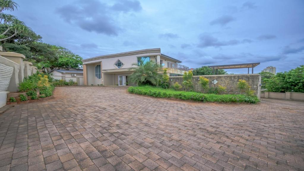 a house with a brick driveway at Villa vasco in Ballito