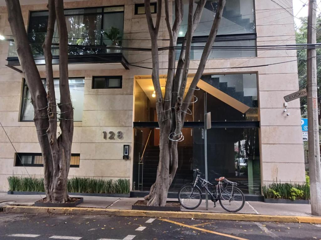 a bike parked in front of a building at Porta Kepler in Mexico City