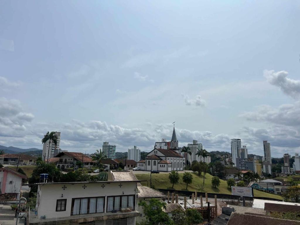 a view of a city with tall buildings and buildings at Suíte com AR BWC Privativo poucos metros da Vila Germânica Oktoberfest in Blumenau