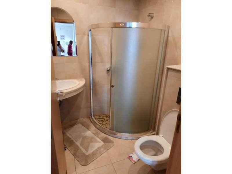 a bathroom with a shower and a toilet and a sink at Sunny Villa in Byala