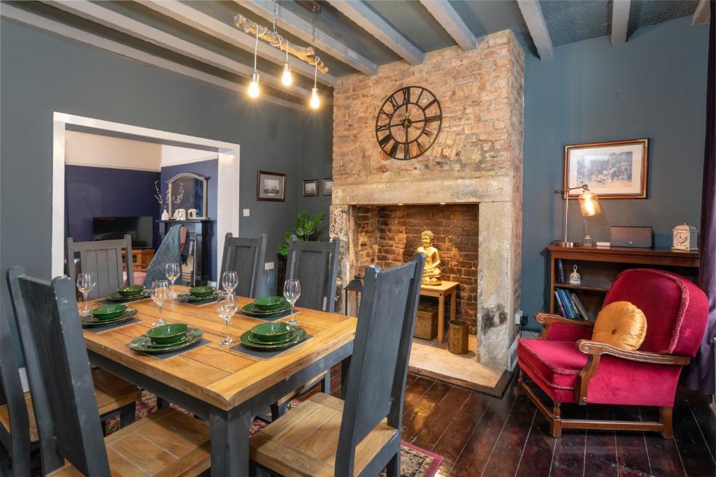 a dining room with a table and a fireplace at Characterful Terrace Retreat in County Durham - Sleeps 6 in Stanley