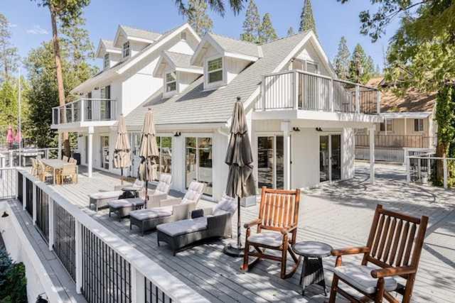 a house with chairs and umbrellas on a deck at Luxury Lake Home-The Bear Claw-Boat Slip-Sleeps 16 in Bass Lake