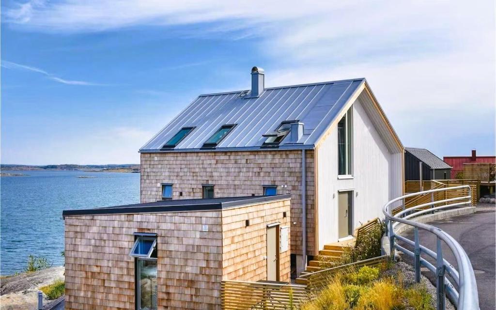 a house with a solar roof on the water at Seaside House for 6 with Panoramic Ocean Views and Sauna near Gothenburg in Kärna