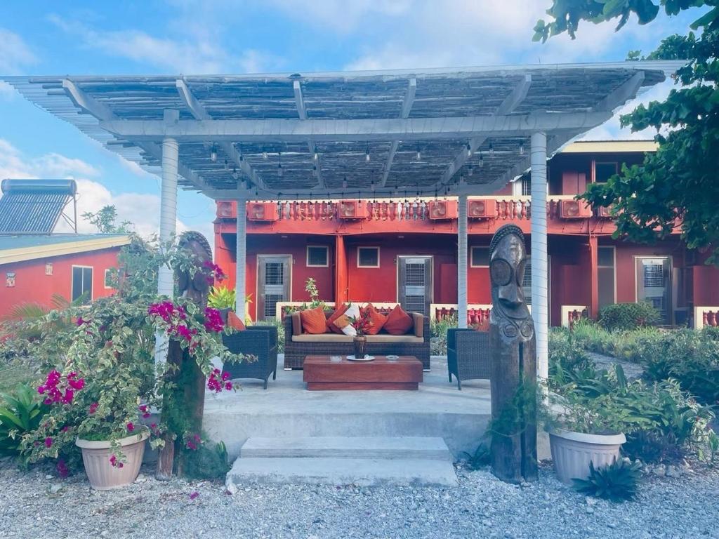 a bench under a pergola in front of a house at Elluk East Studios in Port Vila