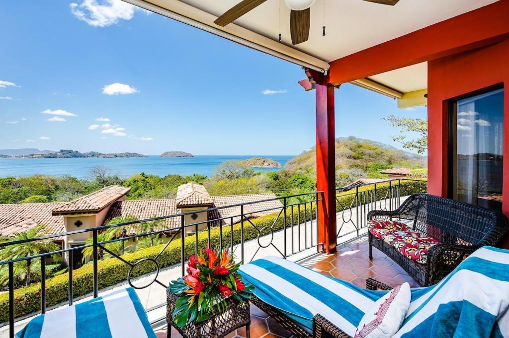 a balcony with chairs and a view of the water at Private Villa, Infinity Pool, 2 Quiet Beaches in Potrero